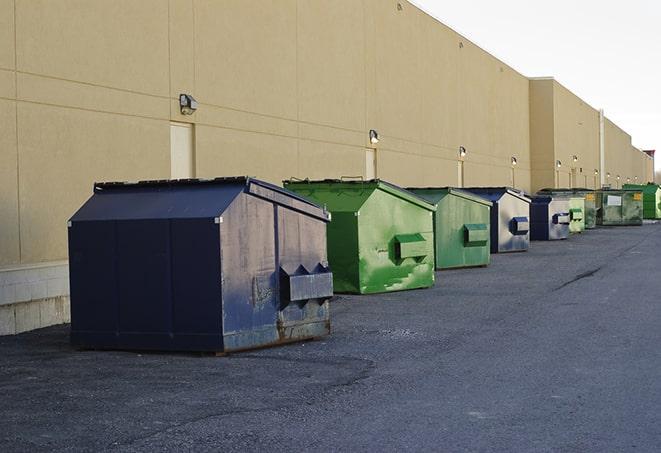 a row of heavy-duty dumpsters ready for use at a construction project in Beasley TX